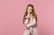 © ViDi Studio - Little cute one kid girl 4-5 years old wearing rose clothes isolated on bright pink wall background, children studio portrait. People sincere emotions, childhood lifestyle concept. Mock up copy space.