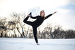 © Kate - Young caucasian female blonde in leggings stretching exercise on open air in snowy forest. fit and sports lifestyle