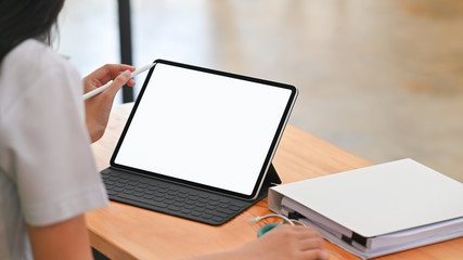 Behind shot woman doctor using isolated white screen of tablet and stylus.