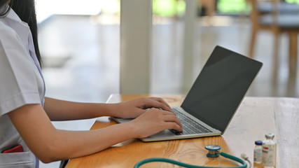 Cropped shot doctor using laptop with research medicine.