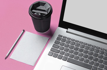 Wall Mural - Workspace minimal concept. Notebook, sheet of paper with a pencil, cardboard container of coffee on pink pastel background