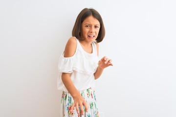 Young beautiful child girl wearing casual dress standing over isolated white background disgusted expression, displeased and fearful doing disgust face because aversion reaction. With hands raised