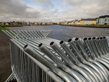 Metal Crowd Control Barriers In Focus, Galway City Out Of Focus, Concept Event, Festival Preparation And Organization.