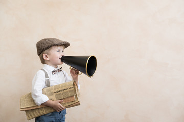 Child shouting through vintage megaphone