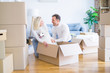 © Krakenimages.com - Young beautiful couple with dog sitting on the floor at new home around cardboard boxes