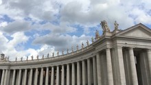 Panoramic Motion To The Right Of The Camera That Slowly Reveals The Beginning Of The Right Colonnade Of The Basilica Of San Pietro And Its Statues Resting On The Top Of The Arcade In A Cloudy Day