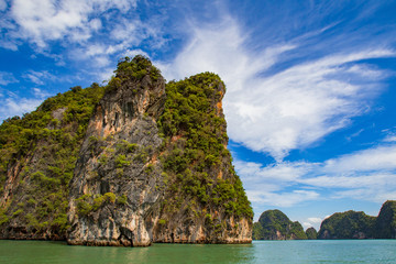 Wall Mural - Thailand. Andaman Sea. Islands of the Andaman Sea near Phuket. Cruises to Thailand. Nature of Thailand. Landscape Southeast Asya. Rock in the water on the background of blue sky. Travels Andaman Sea