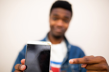 african man pointing to mobile phone screen