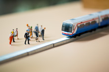 Miniature People Waiting Train At Early Morning Rush Hours. Thai Public Transportation Concept