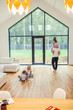 © alfa27 - White interior of room, big panoramic windows. Family playing with each other. Cheerful parents and children at home