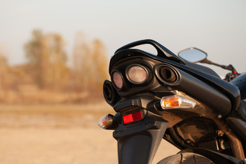 Wall Mural - One black motorcycle in the desert.