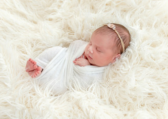 newborn baby sleeping on a little pillow