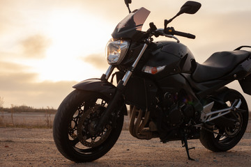 Wall Mural - One black motorcycle in the desert.