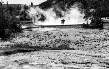 Two girls on wooden walkway posing with steam background in black and white