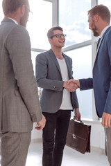 Wall Mural - business people greet each other in the office lobby