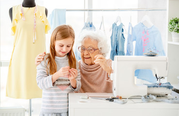 Senior woman instructing little girl