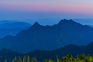 Wall Mural - High angle viewpoint sunset over mountains and forest