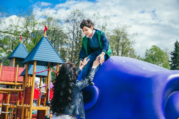 Wall Mural - Little cute boy is having fun outdoor in summer. Playing in children zone in amusement park.