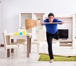 © Elnur - Young man cleaning floor with broom