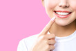 © Aleksandr Rybalko - Perfect healthy teeth smile of a young woman. Teeth whitening. Dental clinic patient. Image symbolizes oral care dentistry, stomatology. Pink Background