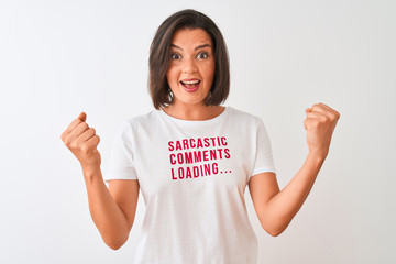 Young beautiful woman wearing fanny t-shirt standing over isolated white background screaming proud and celebrating victory and success very excited, cheering emotion