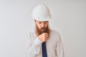 Poster - Young redhead irish architect man wearing security helmet over isolated white background feeling unwell and coughing as symptom for cold or bronchitis. Healthcare concept.