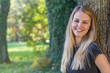 © frank11 - Portrait of attractive long haired young girl smiling at the camera in autumn park.