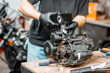 Man Repairing Motorcycle Engine