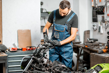 Mechanic repairing or tuning motorcycle