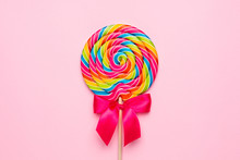 Colorful Lolipop Spiral With Wooden Stick On Pink Background , Childhood Sweets