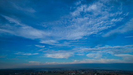 Wall Mural - Aerial View of a Late Afternoon Sun With Partly Cloudy Blue Sky Over Farm Countryside Background