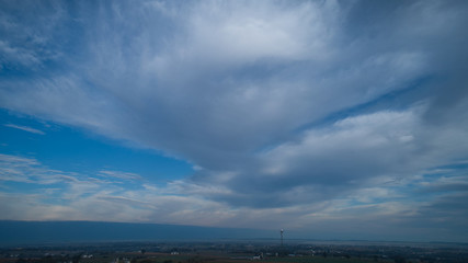 Wall Mural - Aerial View of a Late Afternoon Sun With Partly Cloudy Blue Sky Over Farm Countryside Background