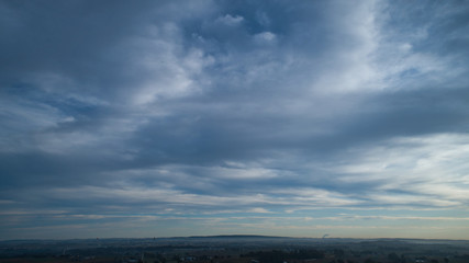 Wall Mural - Aerial View of a Late Afternoon Sun With Partly Cloudy Blue Sky Over Farm Countryside Background