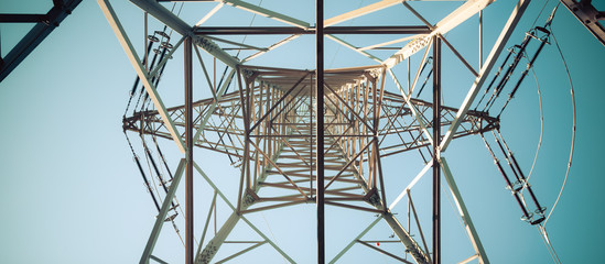 close up of electrical tower and blue sky. renewable energy and smart grid.