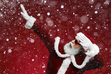 Waist Up Portrait Of Funky Santa Dancing Over Red Background With Snow Falling, Copy Space