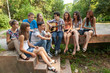 © Andriy Petrenko - Cheerful teenagers playing guitar and singing