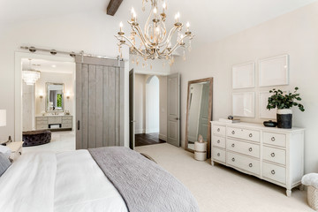 Beautiful master bedroom in new luxury home with view of ensuite bathroom.