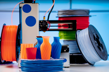 Poster - 3D Printer Plastic filament for 3D printer and printed products in the interior of the design office