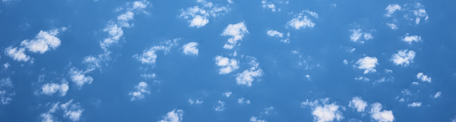 blue cloudy sky, view from the airplane window. aerial view of cloudscape, abstract background. long