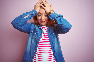 Poster - Beautiful redhead woman wearing denim shirt and striped t-shirt over isolated pink background suffering from headache desperate and stressed because pain and migraine. Hands on head.