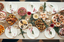Top View Background Of Beautiful Christmas Table With Delicious Homemade Food Decorated With Fir Branches, Copy Space