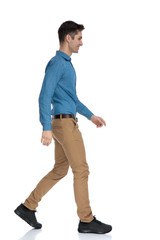 Sticker - side view of smart casual man smiling and walking