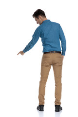 back view of smart casual man pointing finger down