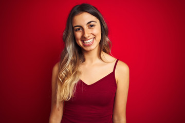 Sticker - Young beautiful woman wearing a t-shirt over red isolated background with a happy and cool smile on face. Lucky person.