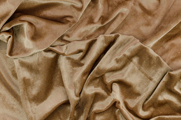 Top view messy gold bed sheets wrinkled fabric texture