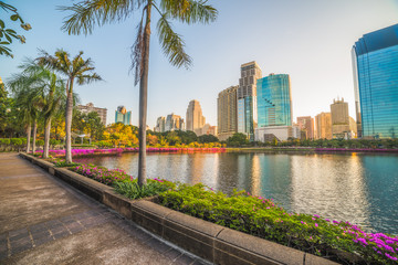 Wall Mural - Nice Runing Track in the City Park. Wonderful View of Benjakiti Park at Sunrise. Beautiful Morning Scene of Public Park in Bangkok, Thailand, Asia.