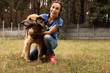 © New Africa - Female volunteer with homeless dog at animal shelter outdoors