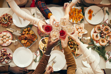 Top View Background Of People Raising Glasses Over Festive Dinner Table While Celebrating Christmas With Friends And Family, Copy Space