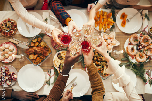 Cuadros en Lienzo Top view background of people raising glasses over festive dinner table while ce