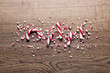 Crushed candy cane on wooden background, flat lay. Traditional Christmas treat